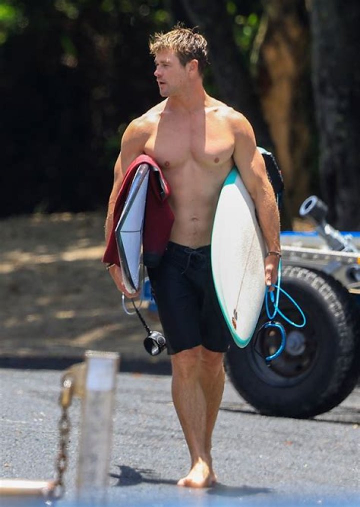 Chris Hemsworth and Elsa Pataky display matching ripped physiques in swimwear for family beach outing