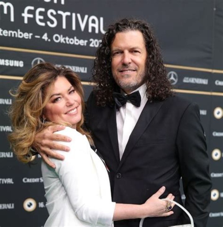 Shania Twain looks phenomenal in thigh-high boots and mini dress as she celebrates milestone with husband